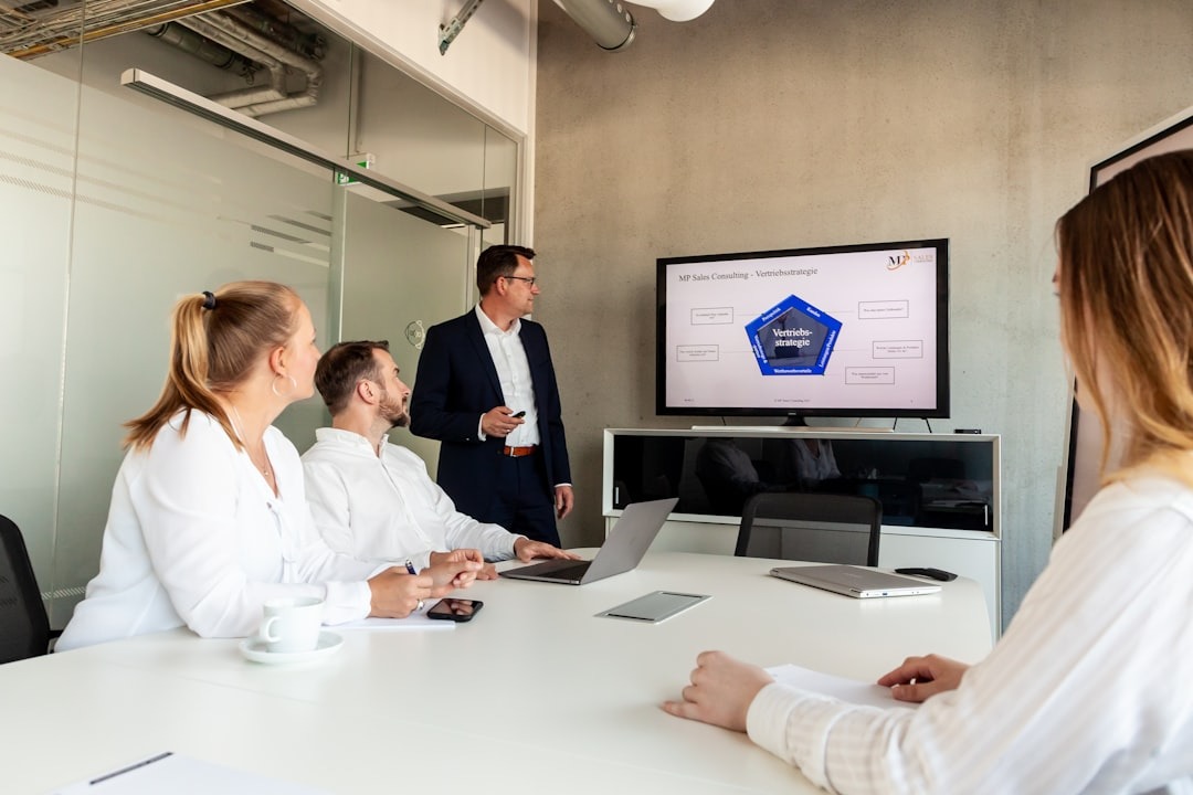 Man presenting a business strategy to colleagues in a modern office.